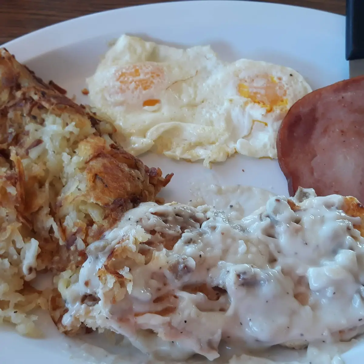 Sausage Gravy Eggs Sliced Ham with Hashbrowns