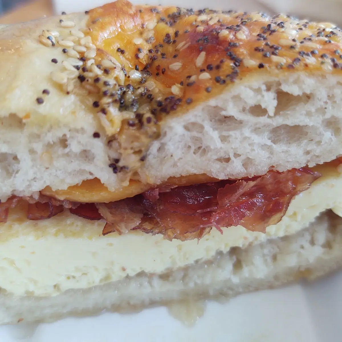 Bacon Egg Cheese on an Everything Cheddar Bagel Though Ordered with Sausage