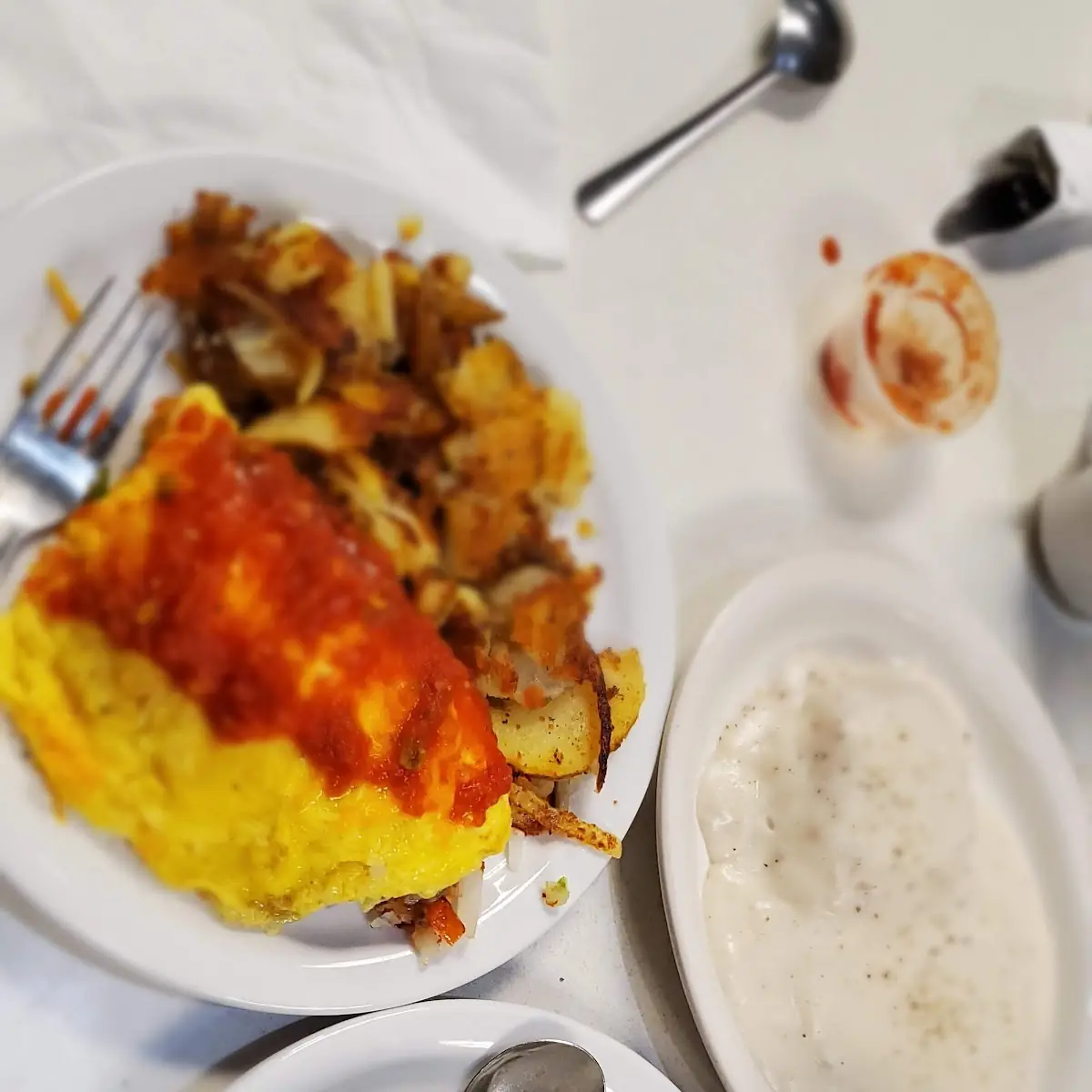 Vegetable Omelet Fried Potatoes with Grilled Onions Biscuit with Cream Gravy and Coffee