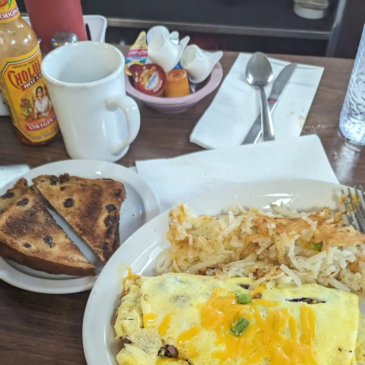 Everything Omelette with Hash Browns and Cinnamon Raisin Bread