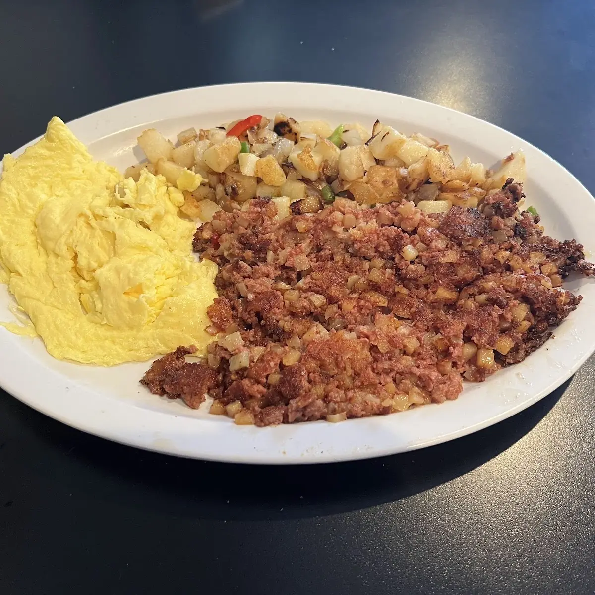 Corned Beef Hash with 2 Eggs Scrambled and Country Potatoes