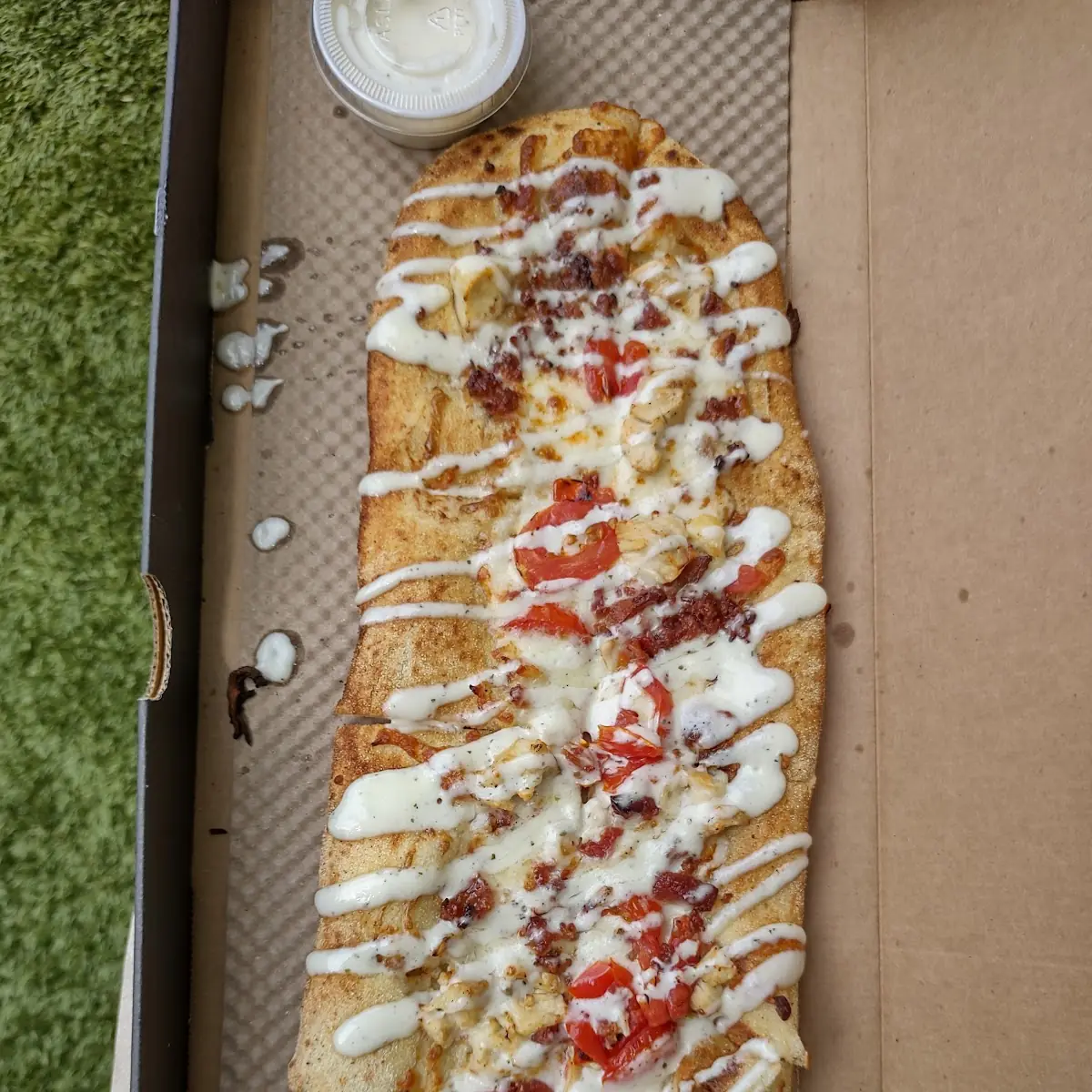A Bacon & Ranch Pizza with Ranch Dressing