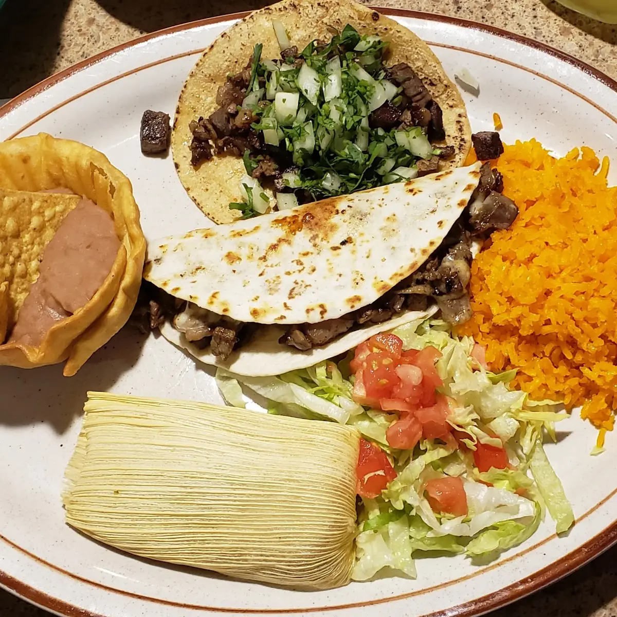 Combination- Steak Taco Steak Quesadilla Chicken Tamale with Beans and Rice