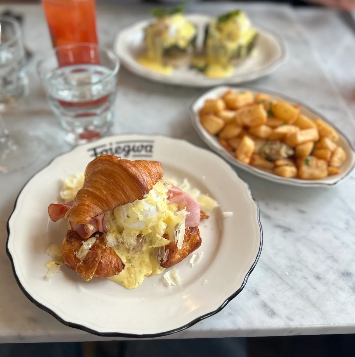 Croissant Benedict with Ham Egg and Cheese and Truffle Hollandaise Sauce