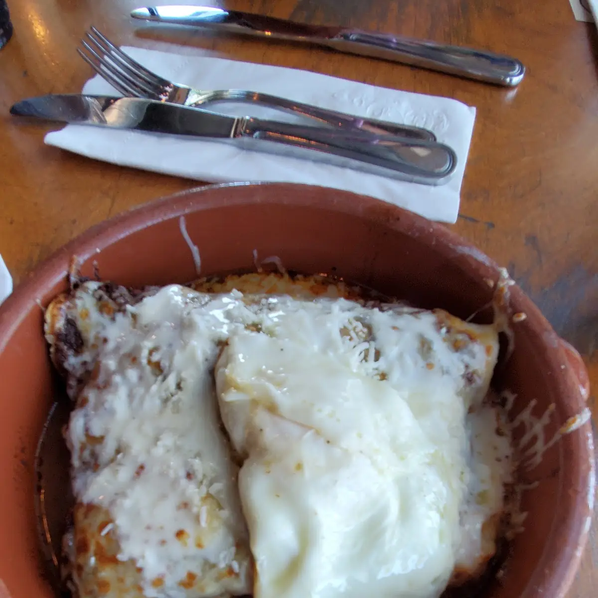 Two Enchiladas on Corn Red Sauce with Egg on Top