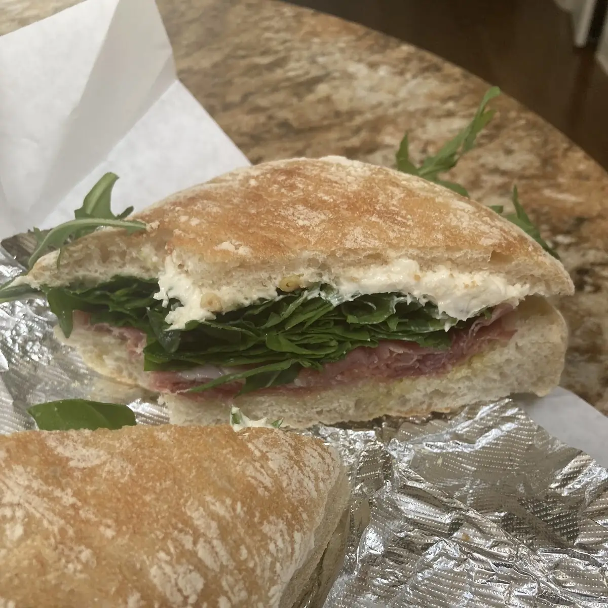 Prosciutto Brie Pine Nuts Arugula Truffle Oil on Ciabatta