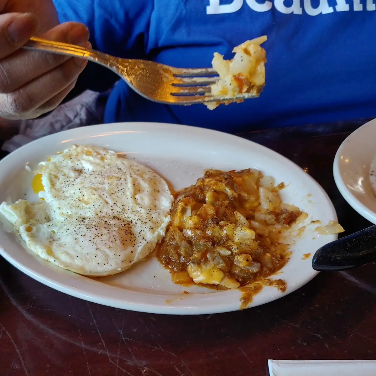 Two Eggs Any Style with Hash Browns Pancakes or Grits