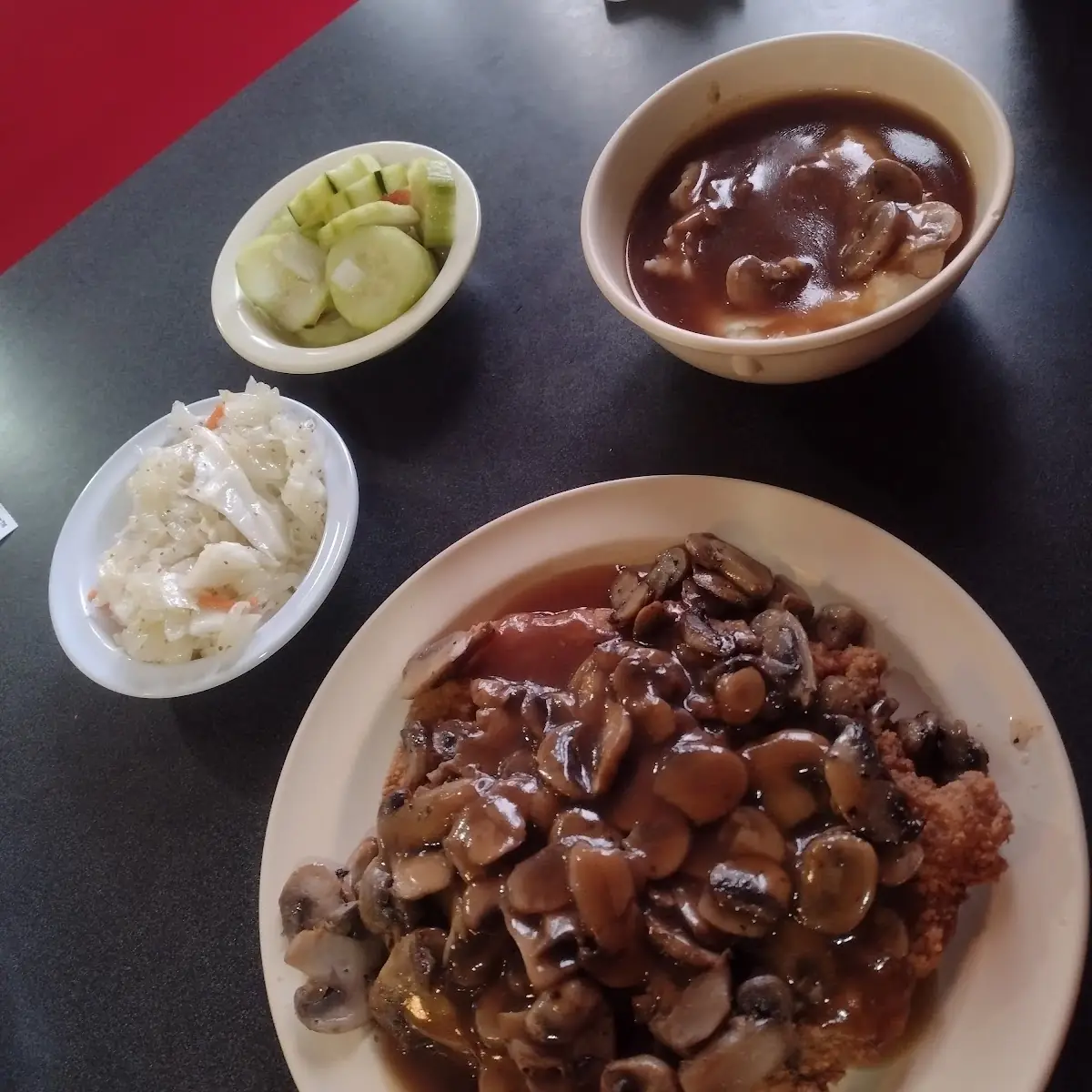 Pork Tenderloin with Mushroom Gravy Mashed Potatoes Cucumber Salad and Coleslaw