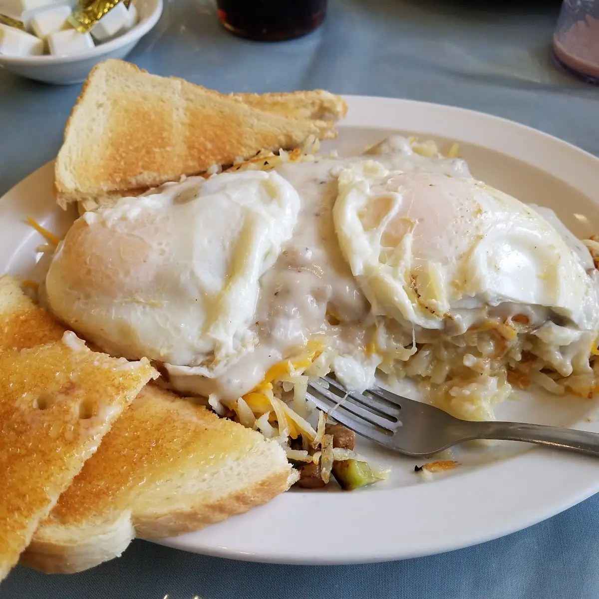Garbage Stuffed Hash Browns w over Easy Eggs on Top