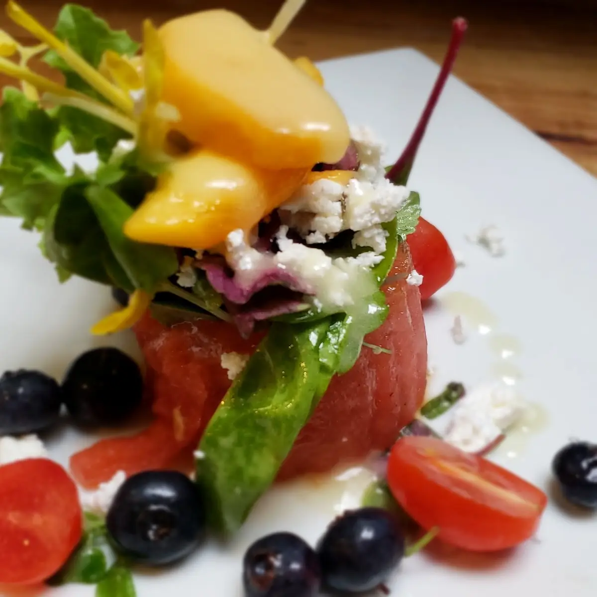 Assorted Micro Green Salad with Grilled Watermelon Tomatoes Feta Blueberries and Peaches