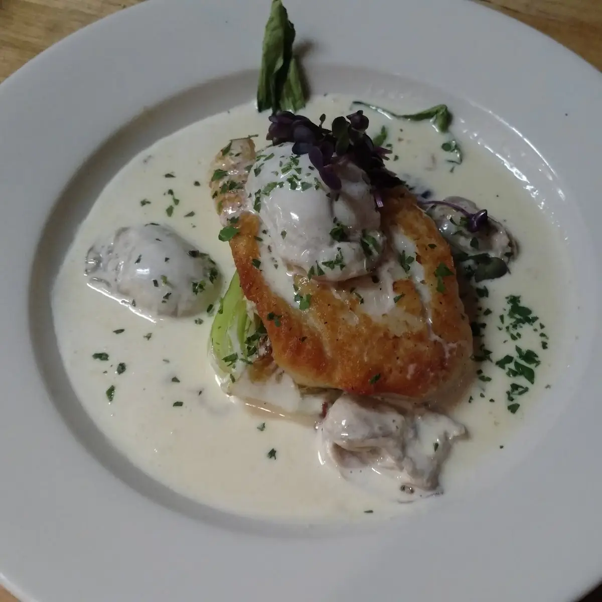 Pan Seared Flounder over and Oyster Stew Served with Grit Cake and Bok Choy