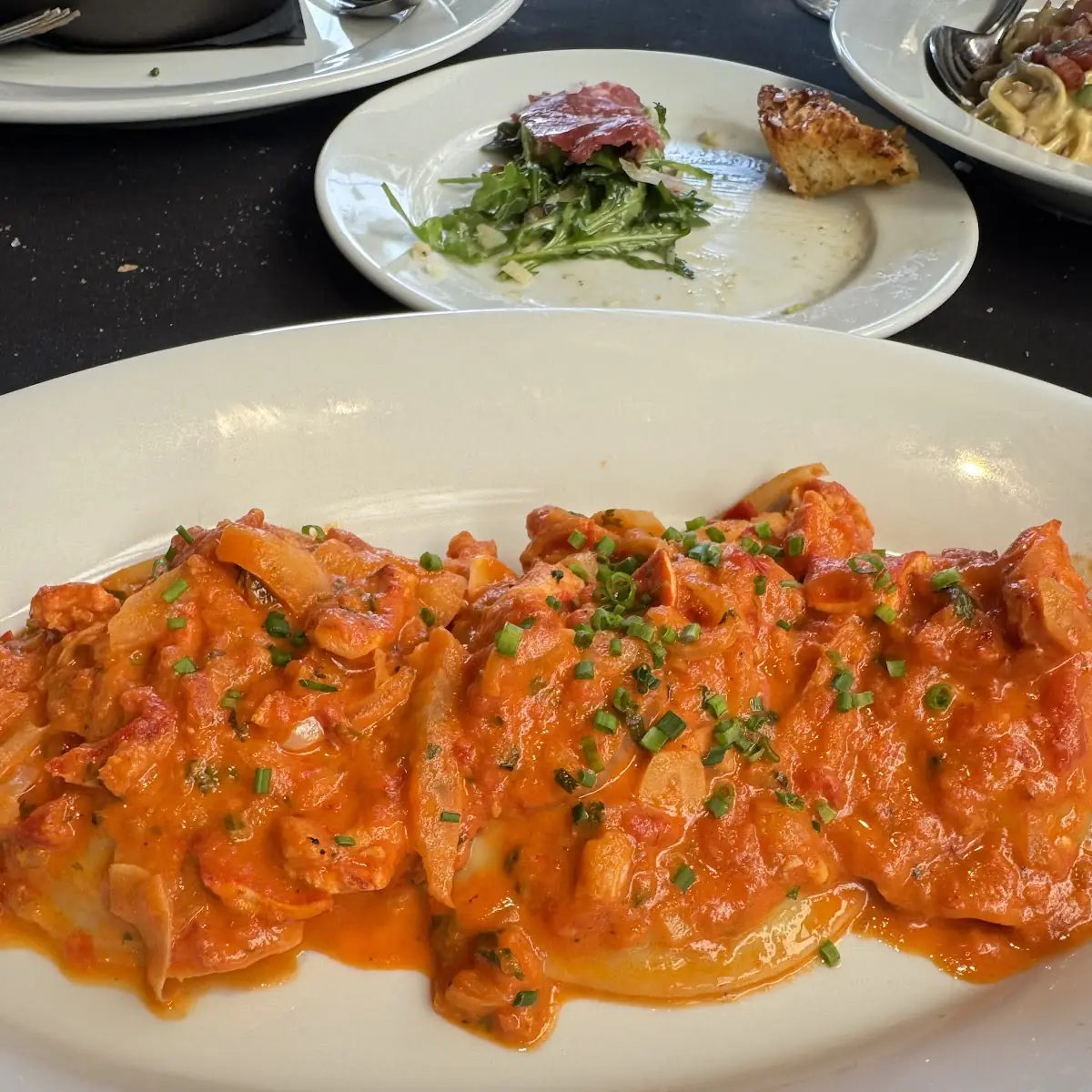 Pumpkin Ravioli with Corn Yellow Tomato Thyme Sauce Sun-Dried Tomatoe Vinaigrette and Crispy Leeks