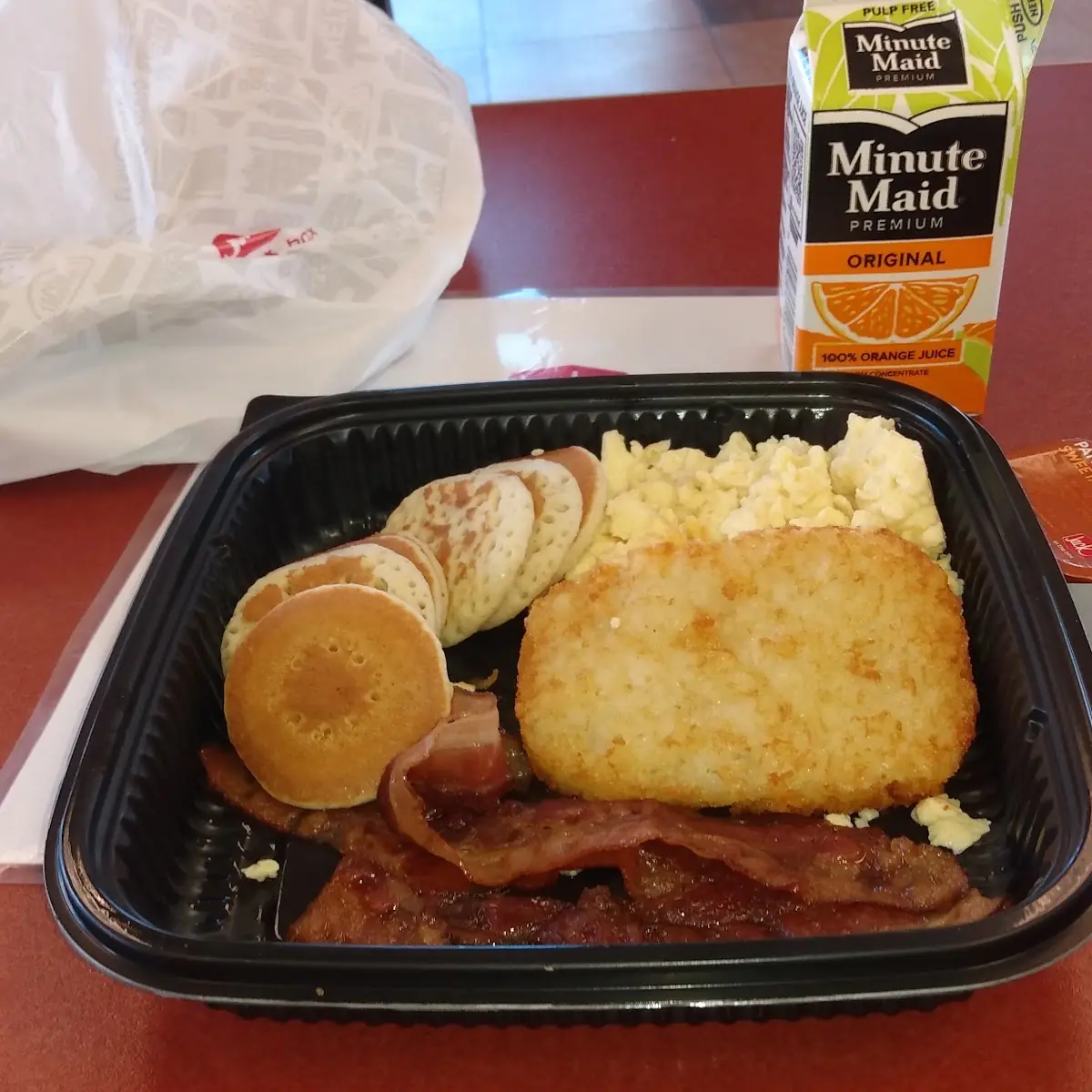 Pancake Breakfast with Eggs Bacon and Hash Brown and Orange Juice