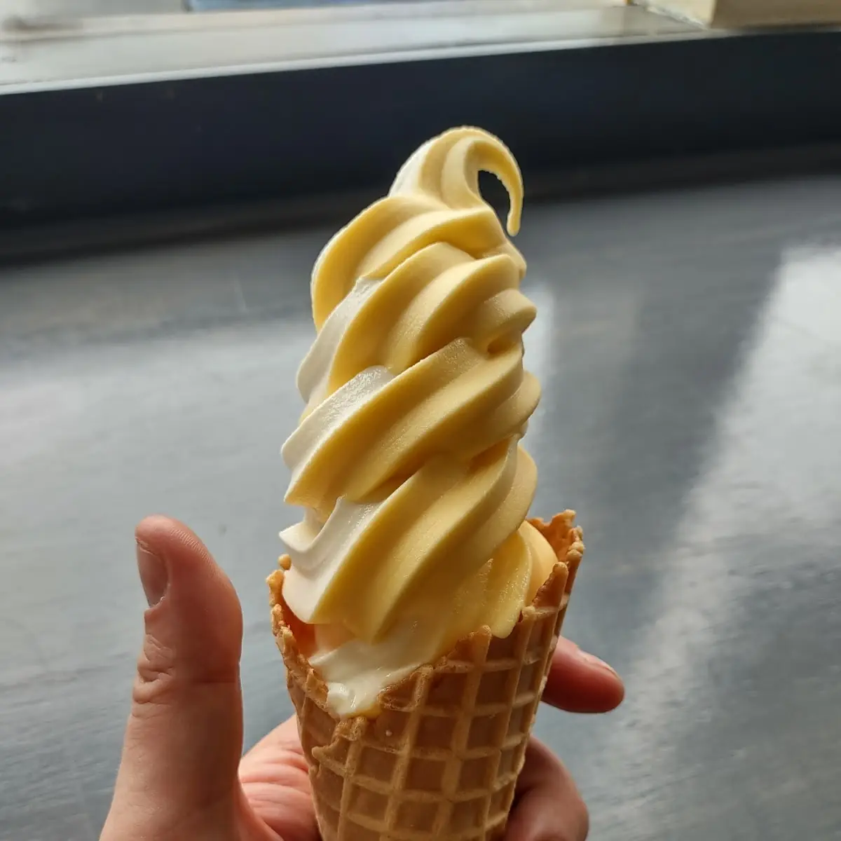 Mango Dole Whip Swirl in Waffle Cone
