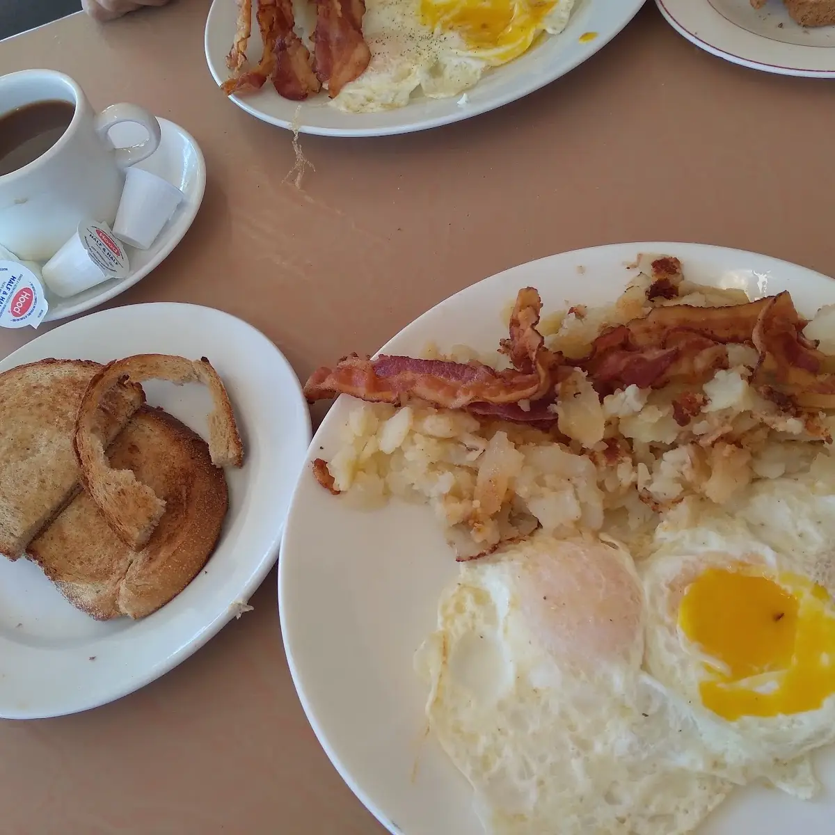Bacon over Light Eggs Hash Browns and Rye Toast