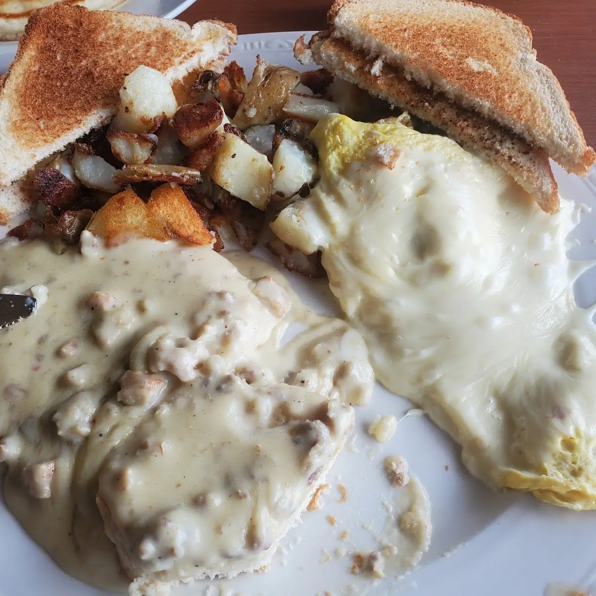 Hunters Sausage Gravy with Biscuits Scrambled Eggs with Cheese Potatoes Toast