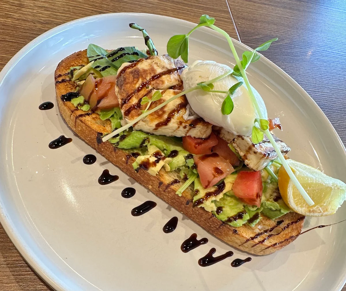 Smashed Avocado on Toasted Sourdough with Spinach Cherry Tomatoes Halloumi and Poached Eggs, Caffe Cherry Beans Bonnyrigg