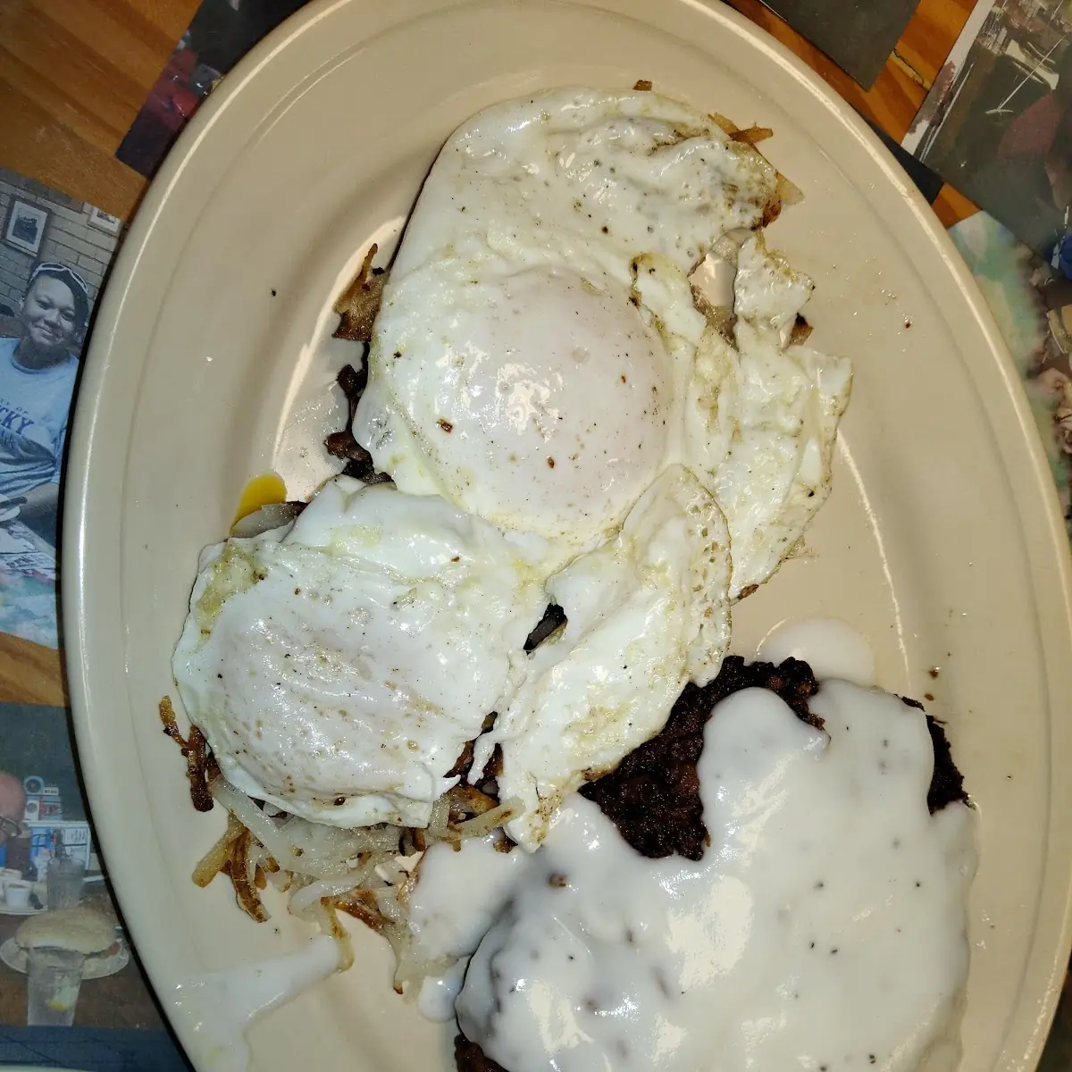 Country Fried Steak over Easy Eggs Hash Browns and White Gravy