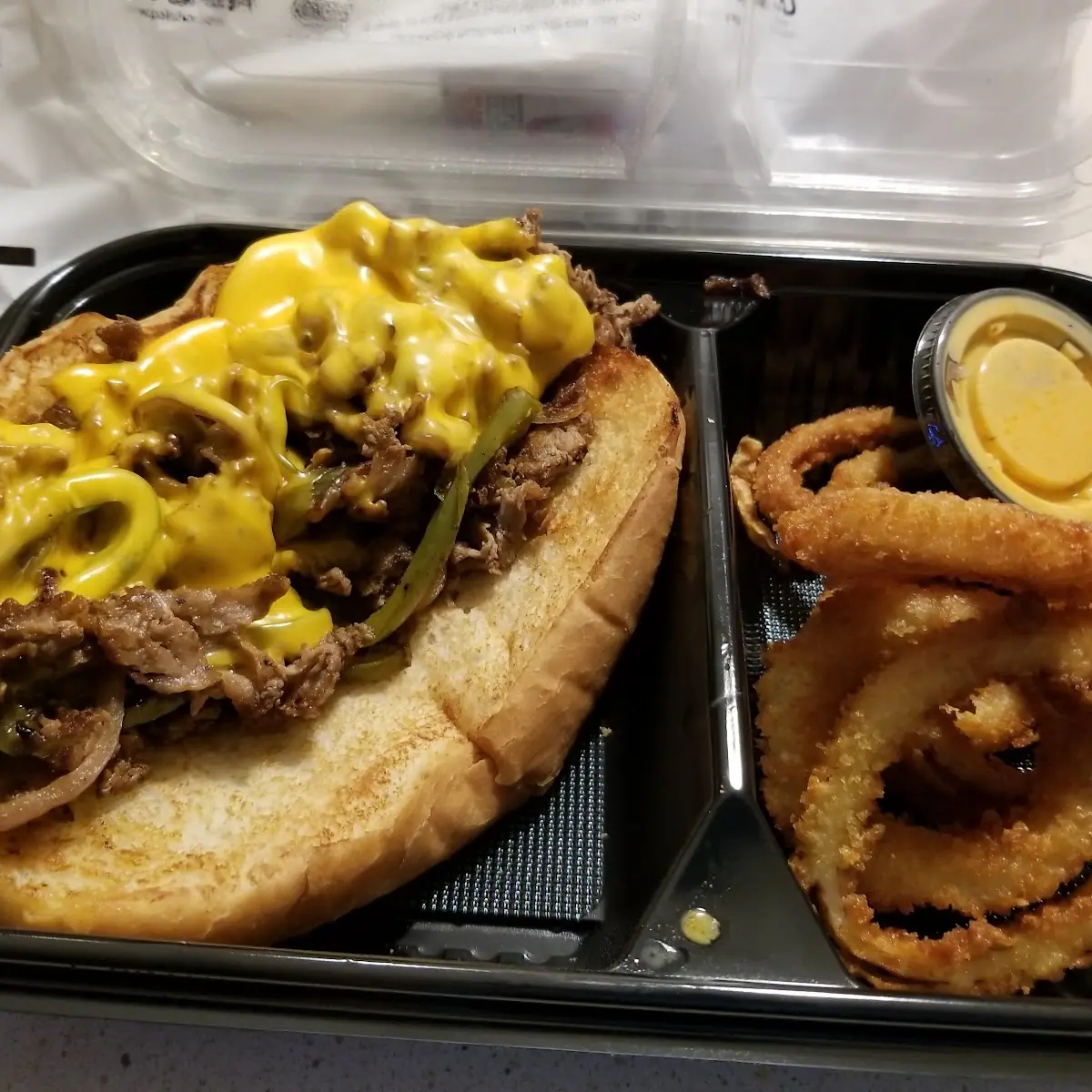 Philly Cheese Steak Sandwich and Onion Rings