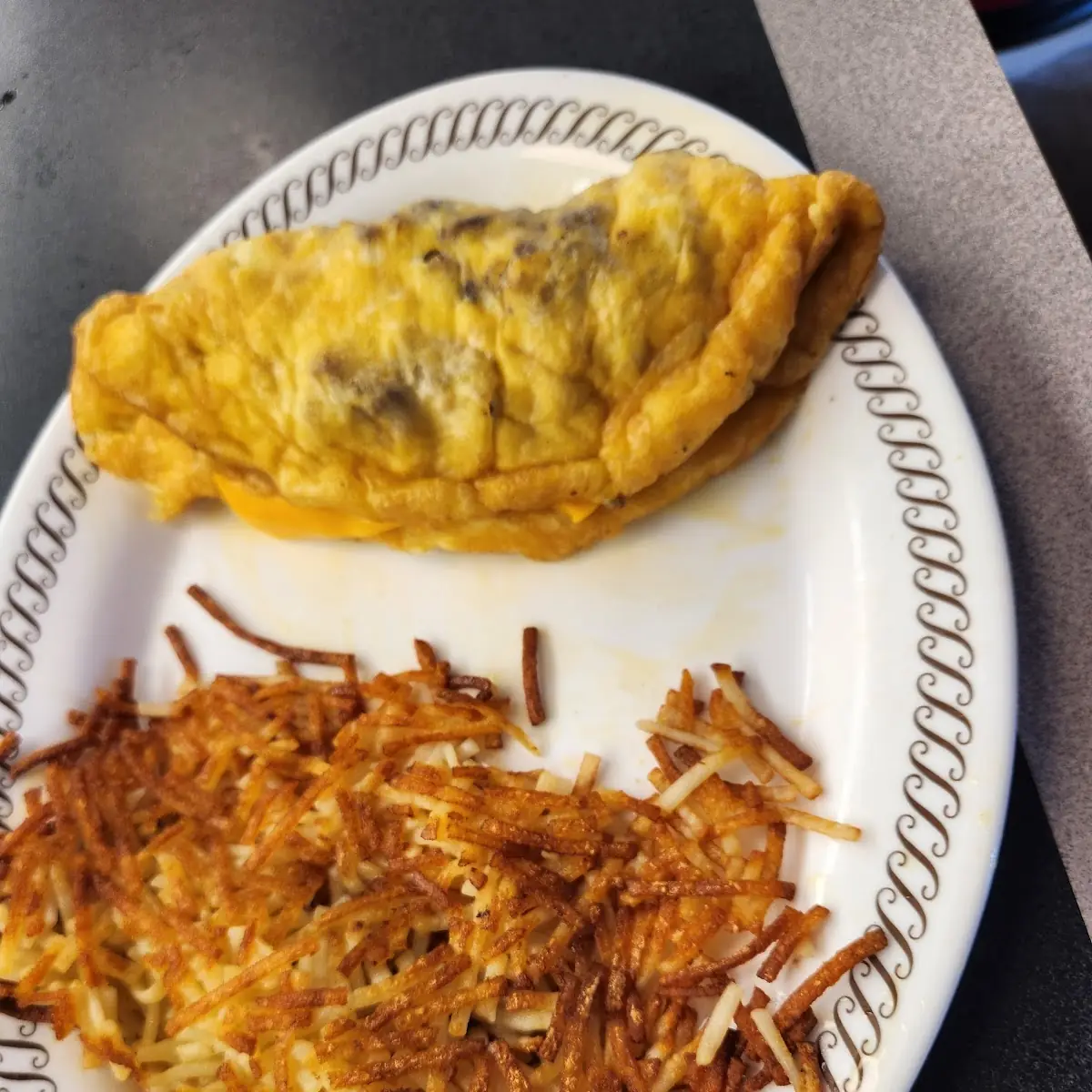 Sausage and Bacon and Cheese Omelet with Hash Browns
