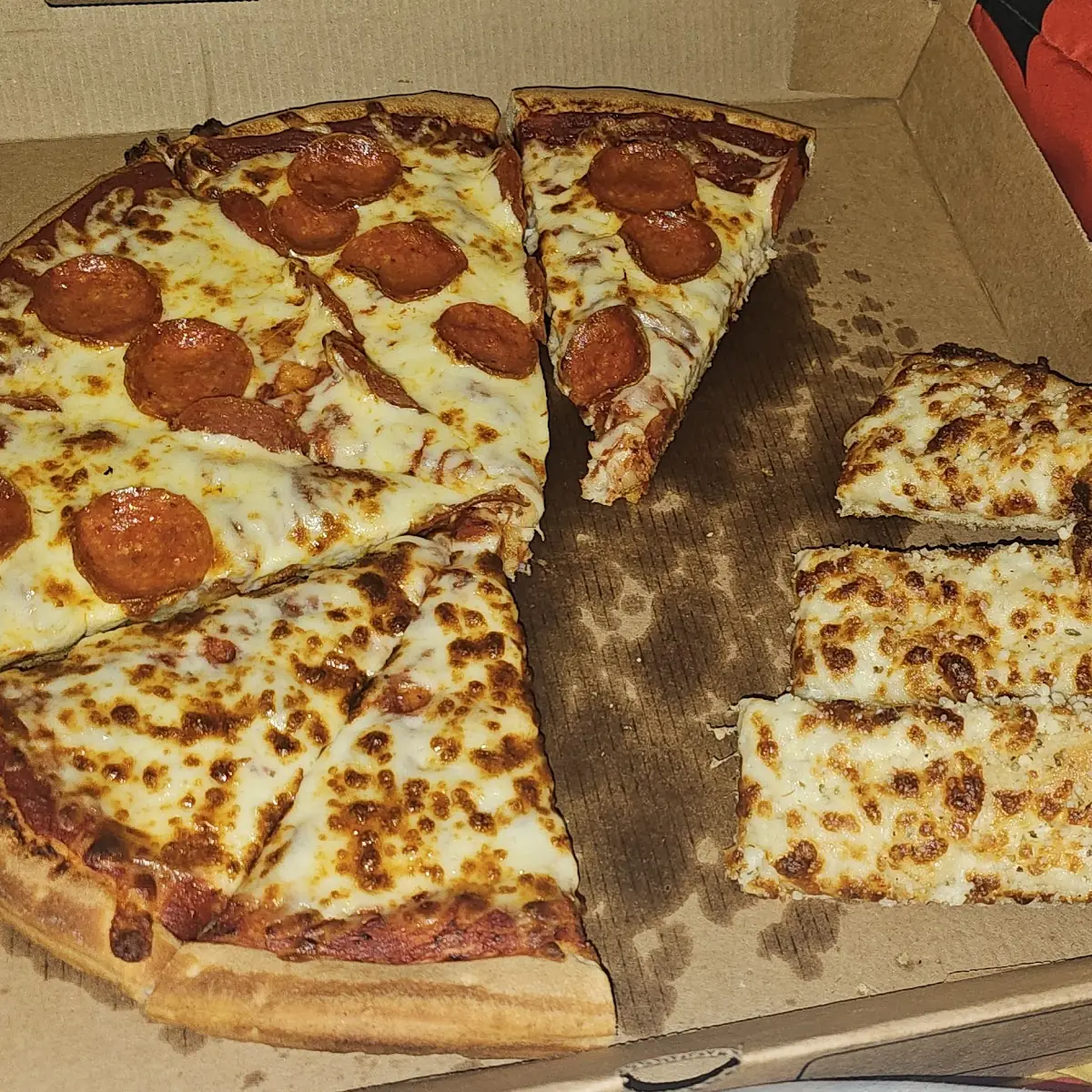 Half Pepperoni Half Cheese Pizza and Cheesesticks