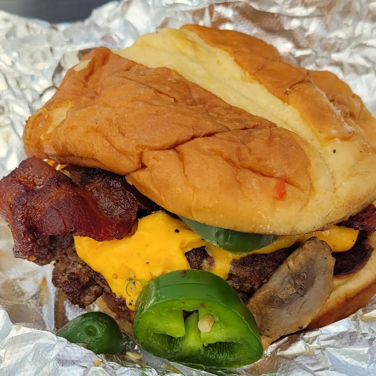 Single Bacon Cheese Burger with Fresh Jalapeños Mushrooms Onions Bacon