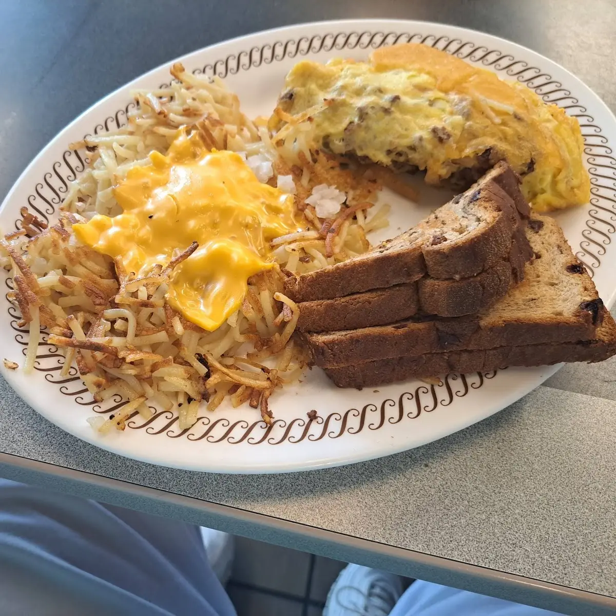 Steak Omelette with Hash Browns Smothered and Covered with Raisin Toast