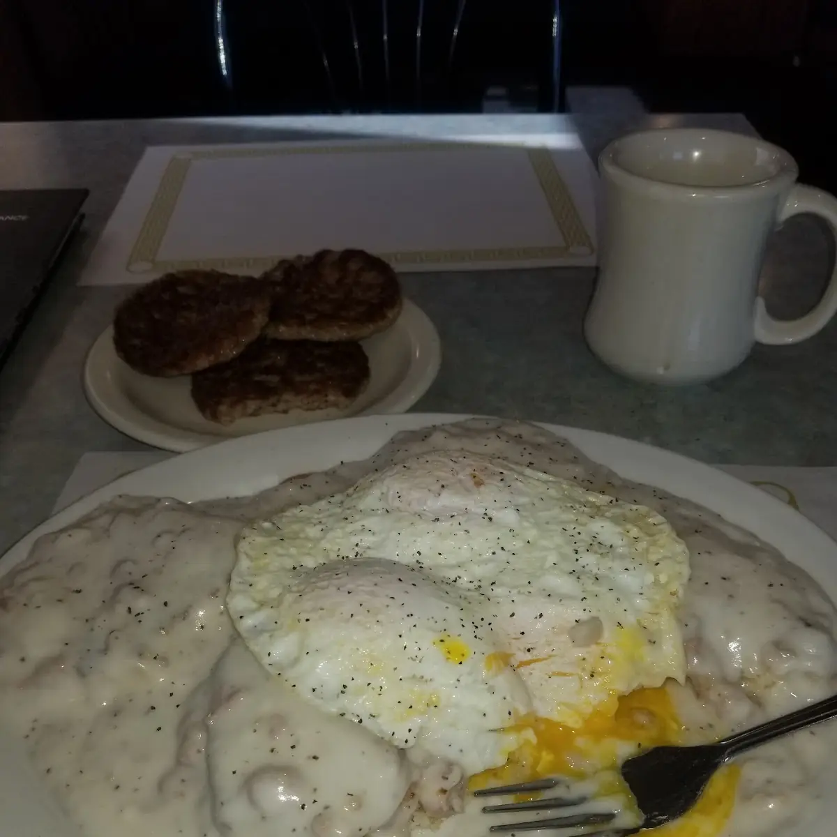 Biscuits and Sausage Gravy with 3 Eggs over Easy
