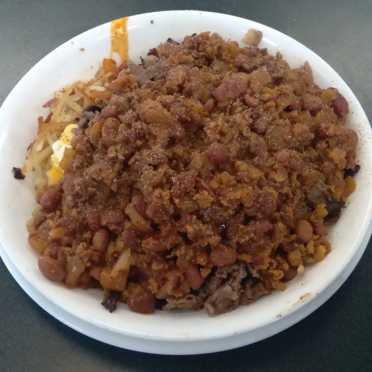 Cheese Steak Bowl with Two Scrambled Cheesy Eggs Riding Piggyback Then Dumped with Chili