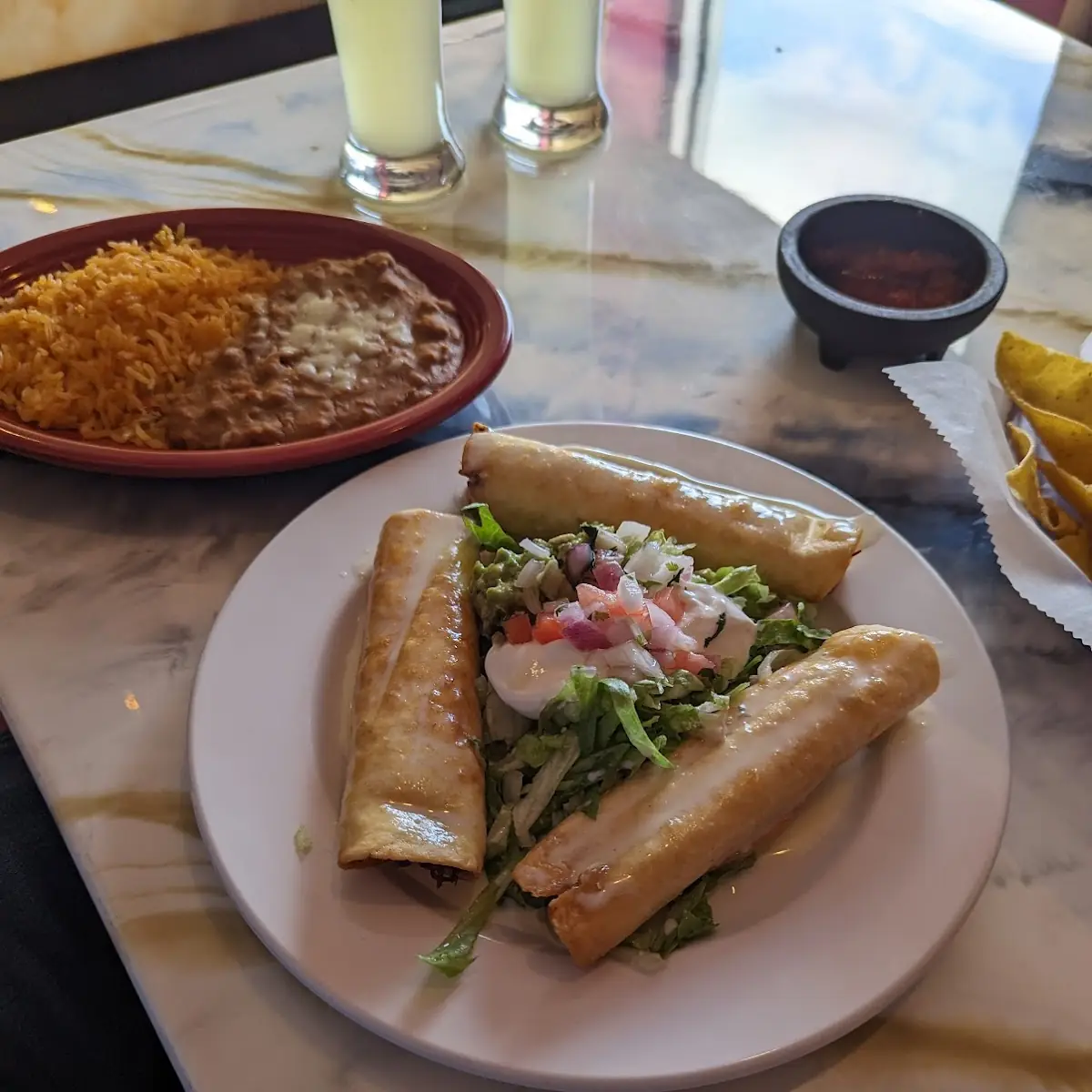 V #14 Spinach and mushrooms soft chimichanga. Topped with cheese dip, lettuce and sour cream. Served with rice.