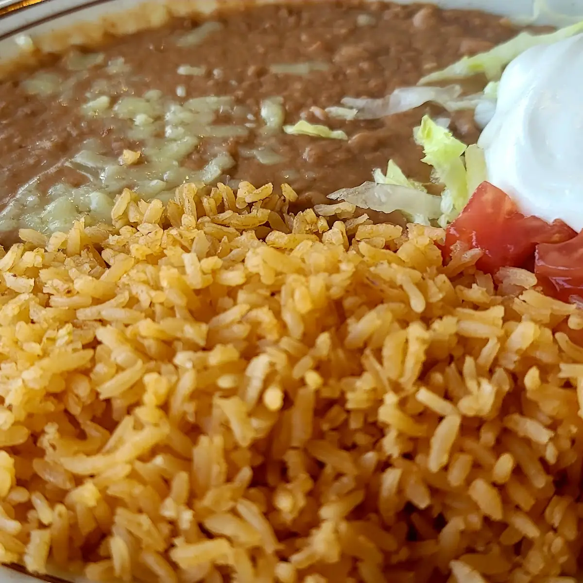 Refried Beans Rice Guacamole Sour Cream Lettuce and Tomato