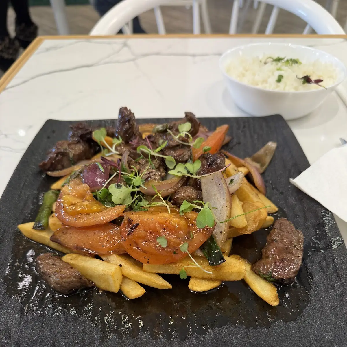 Pollo Saltado. (Chicken saltado with fries and rice)