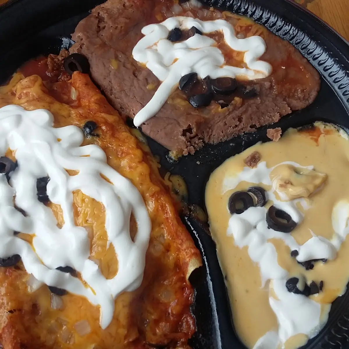 Deluxe Enchilada Dinner Plus Onions Olives and Sour Cream