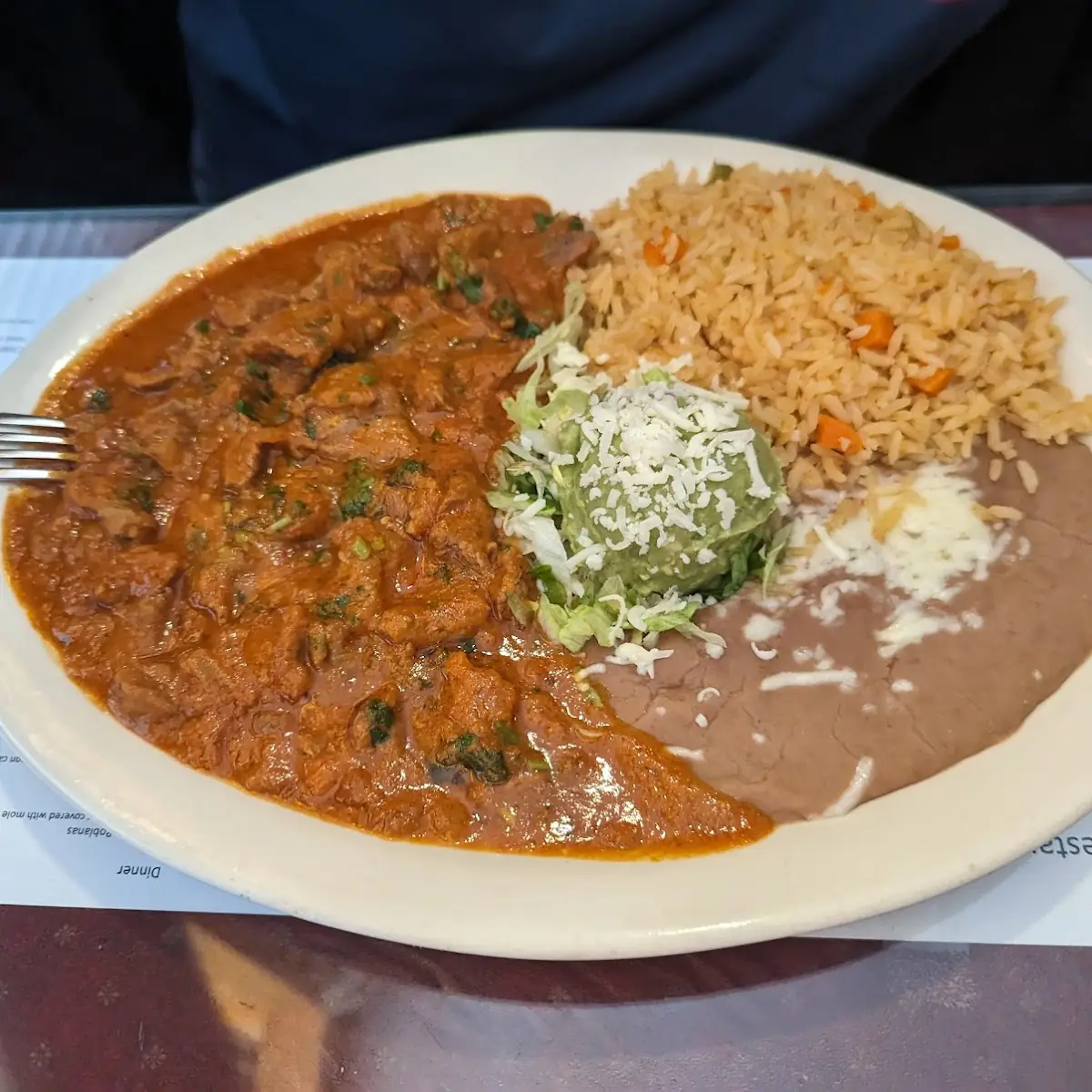One Cheese Enchilada Topped with Chile Con Carne Sauce Rice and Beans