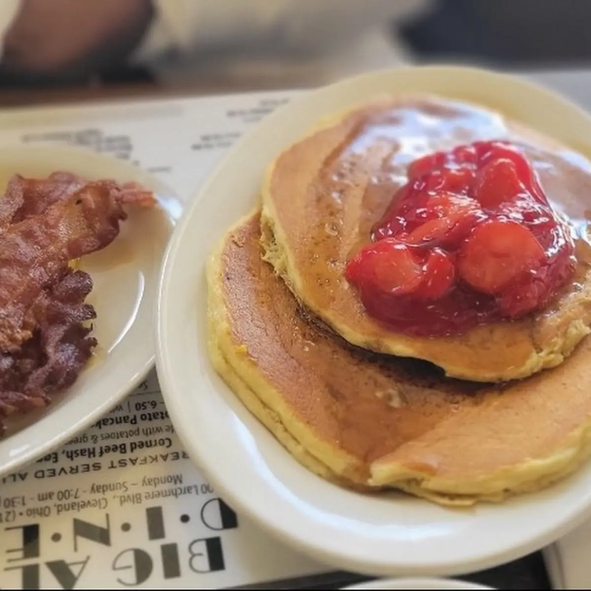 Strawberry Topped Pancakes with Scrambled Eggs and Bacon