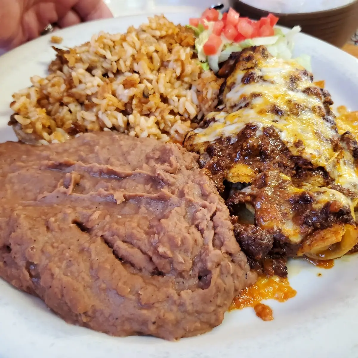 Enchiladas with Chili Sauce Refied Beans and Rice