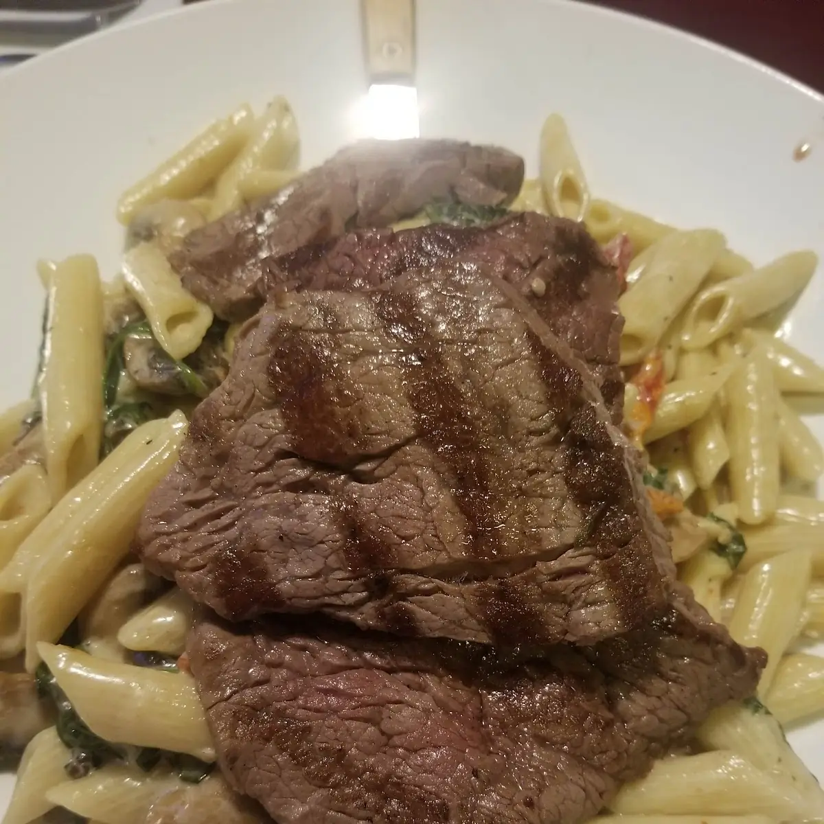 Filet Mignon over Pasta with Mushroom Sun-Dried Tomatoes and Spinach and a Sherry Wine Sauce