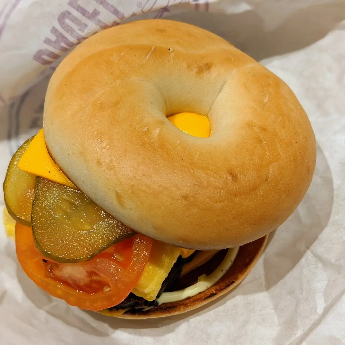 Steak Egg and Cheese Bagle with Pickles and Tomatoes