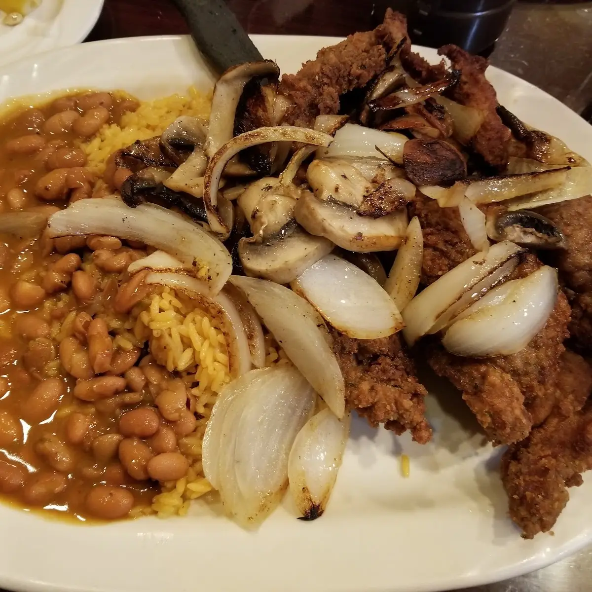 Bistec Empanizado Breaded Fried Steak with Sauteed Mushrooms and Onions