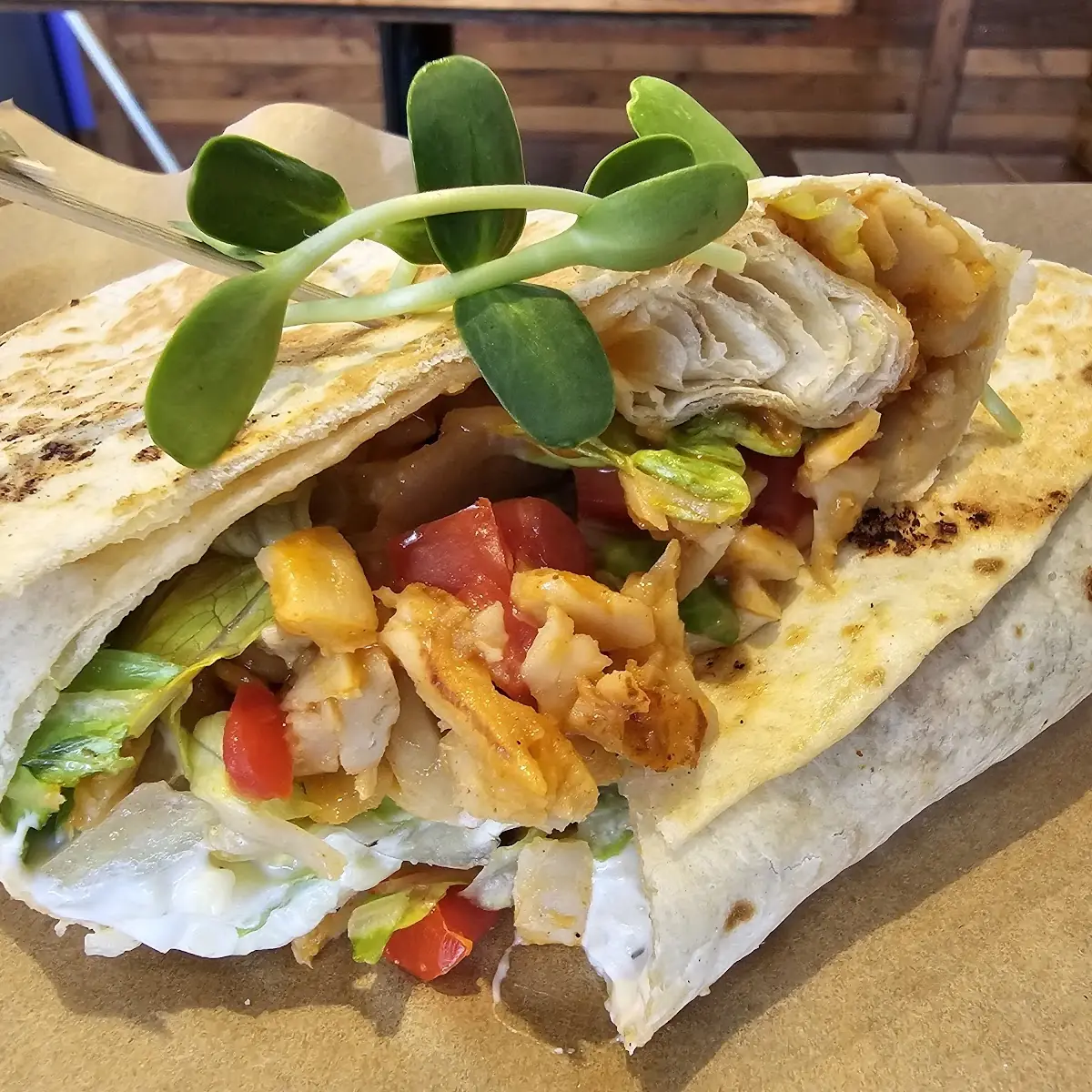 Jackfruit Carnitas Burrito with Black Beans Corn Cheddar Cheese Guac Salsa & Crema