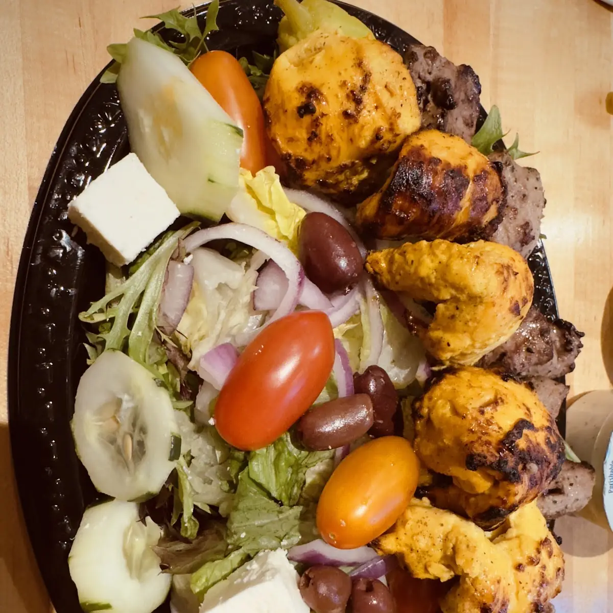 Moby Dick Super Combo a Combination of a Lamb and Chicken Kabob Served over a Mixed Green Salad