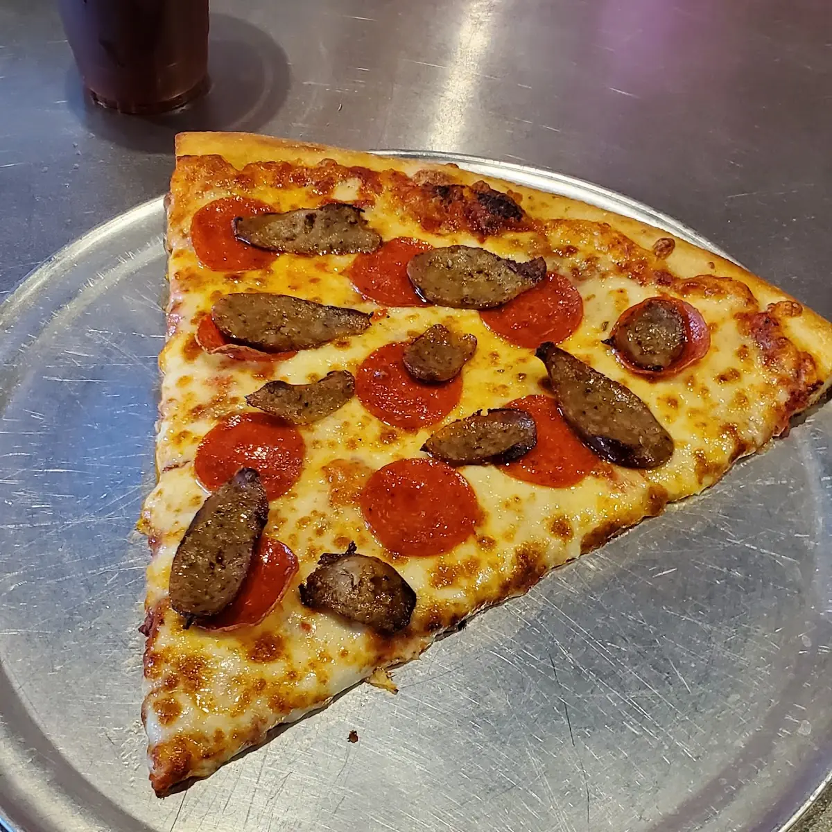 Peperoni and Italian Sausage Pizza Slice