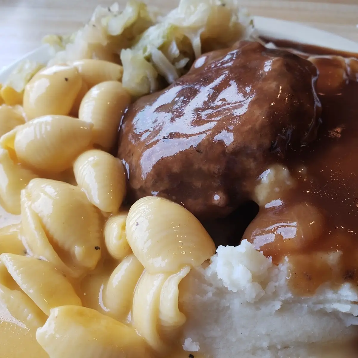 Hamburger Steak and Gravy Mashed Potatoes Cabbage and Macaroni and Cheese