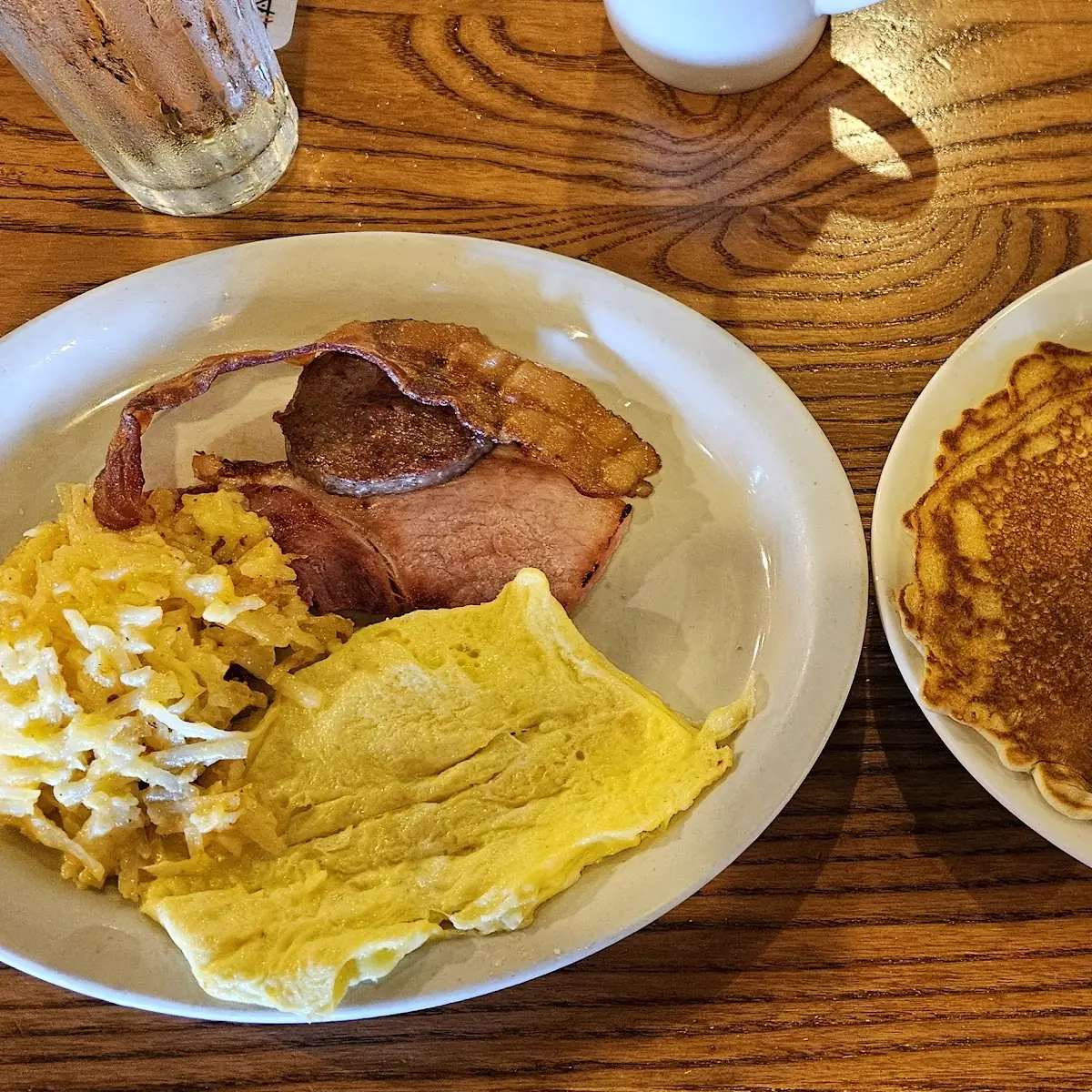 Two Pancakes with Scrambled Eggs and Bacon