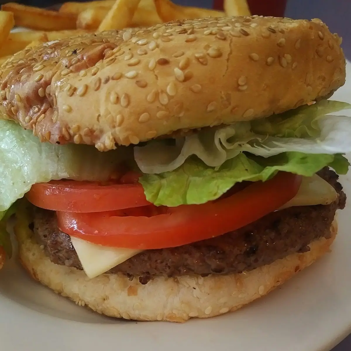 Quarter Pound Cheeseburger with American Cheese Lettuce Tomato on Sesame Seed Bun