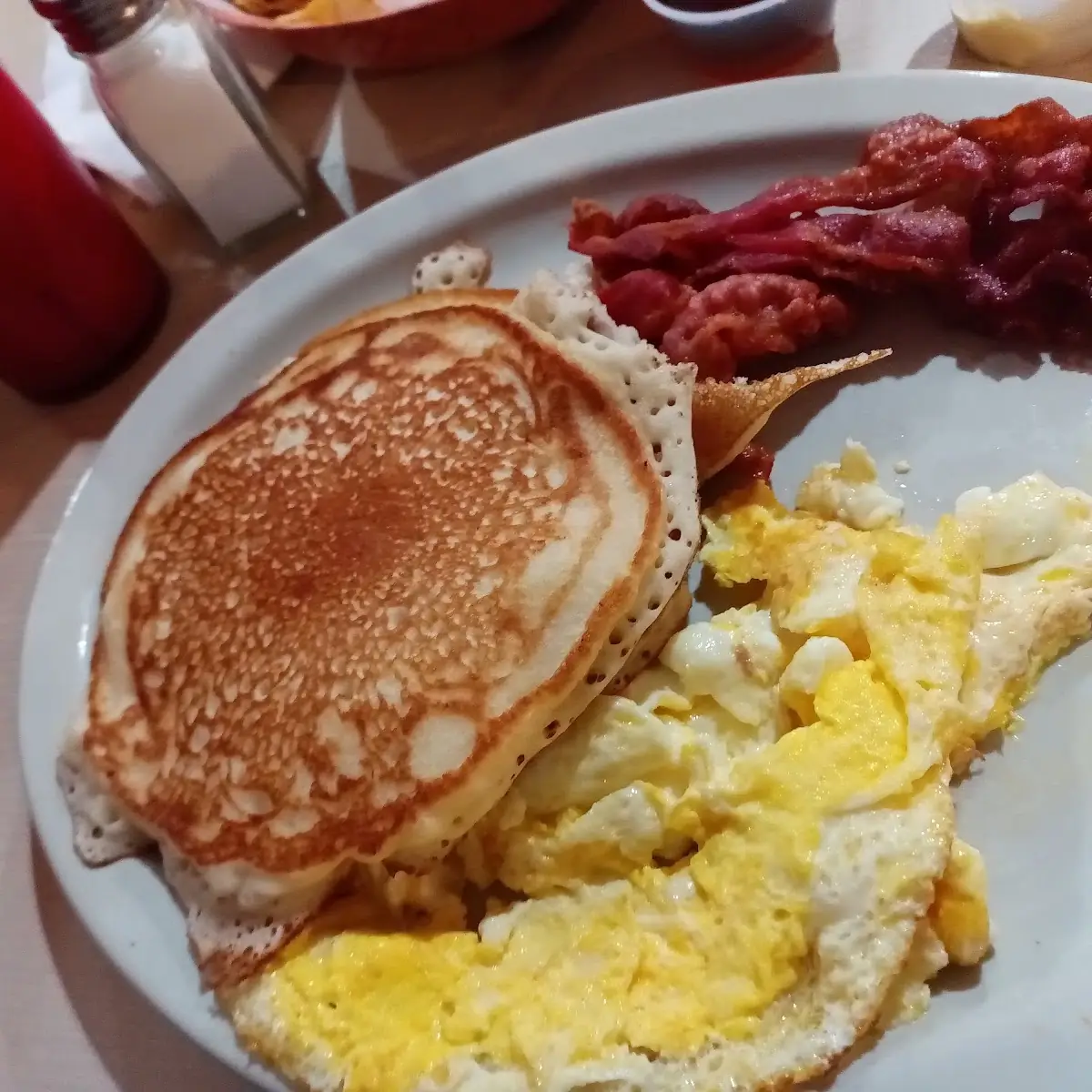 The Pancakes Served with Eggs and Bacon