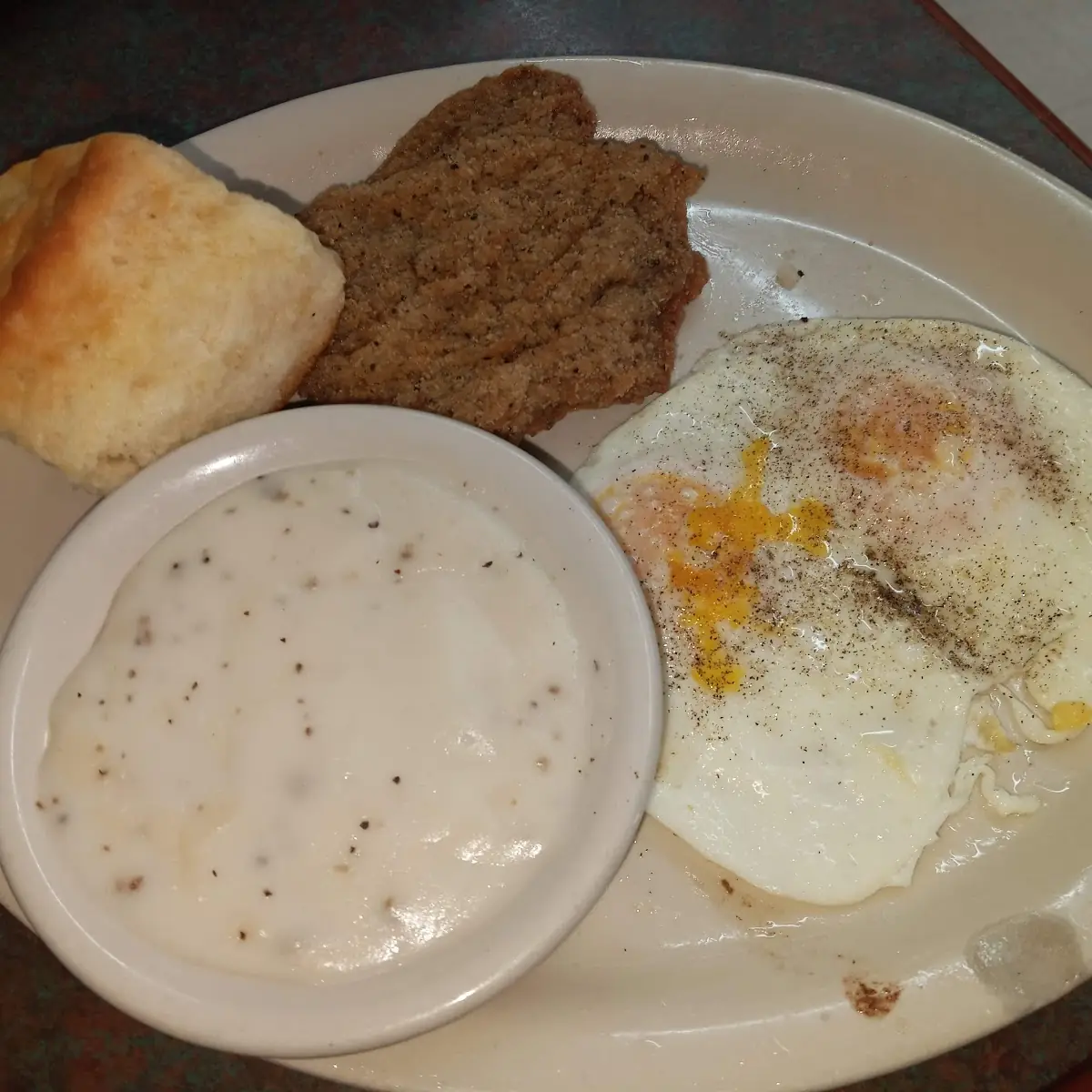 Country Fried Steak Two Eggs over Medium Biscuits and Gravy