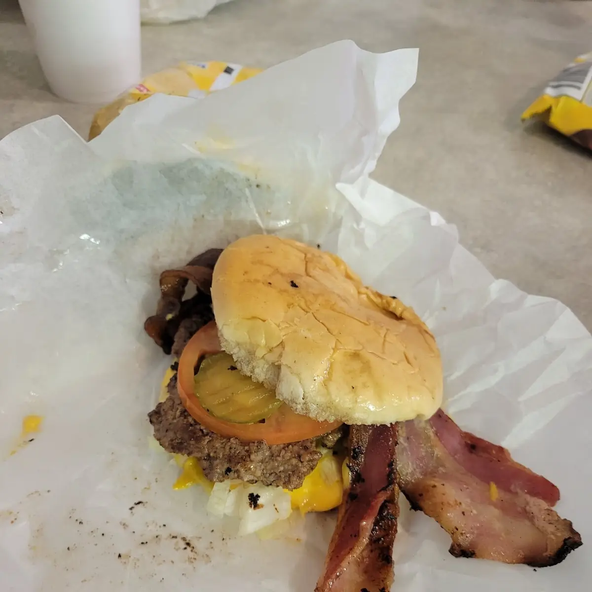 Large Bacon Cheeseburger with Pickles Onions and Mustard