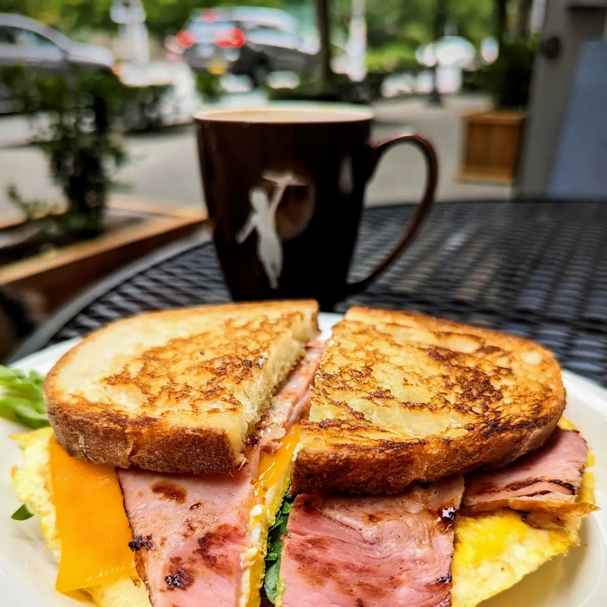 Ham Breakfast Sandwich with 2 Eggs Honey-Cured Ham Cheddar Cheese Arugula and Pesto
