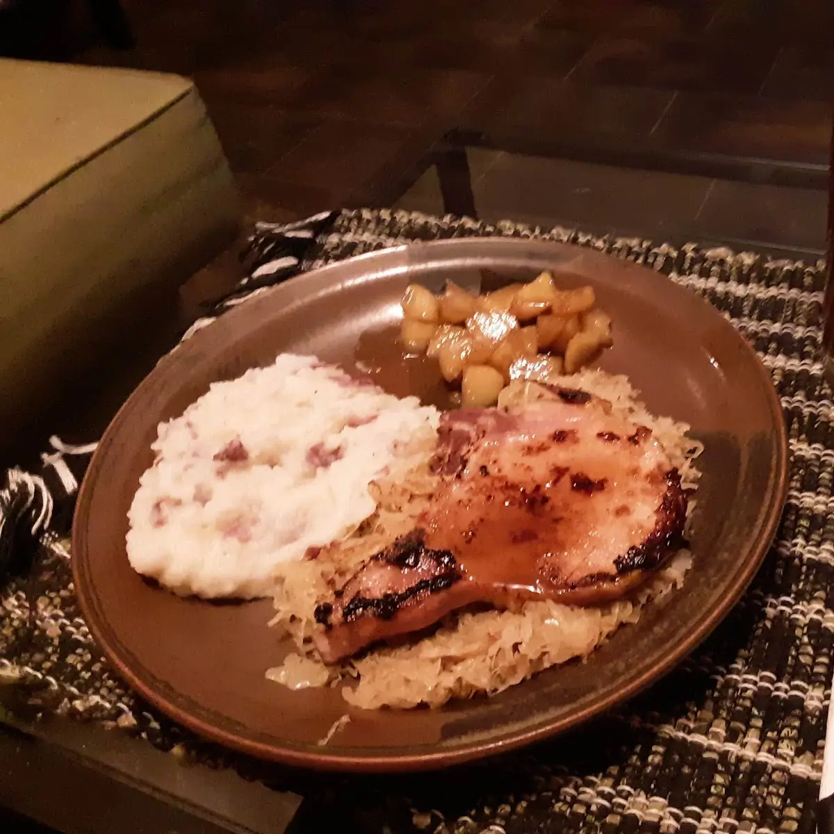 Smoked Pork Chops on Sauerkraut with Mashed Red Potatoes and Sauteed Apples